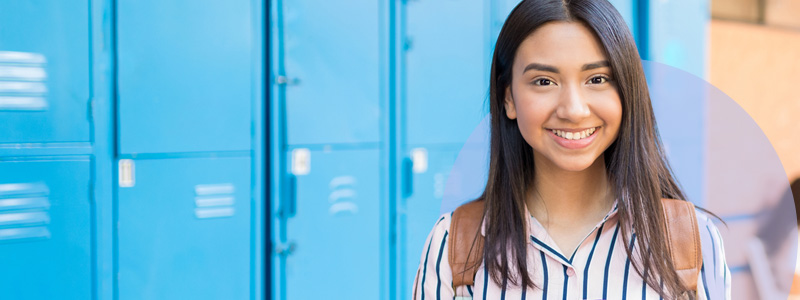 student in front of lockers