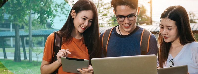 students outside with laptop and tablets